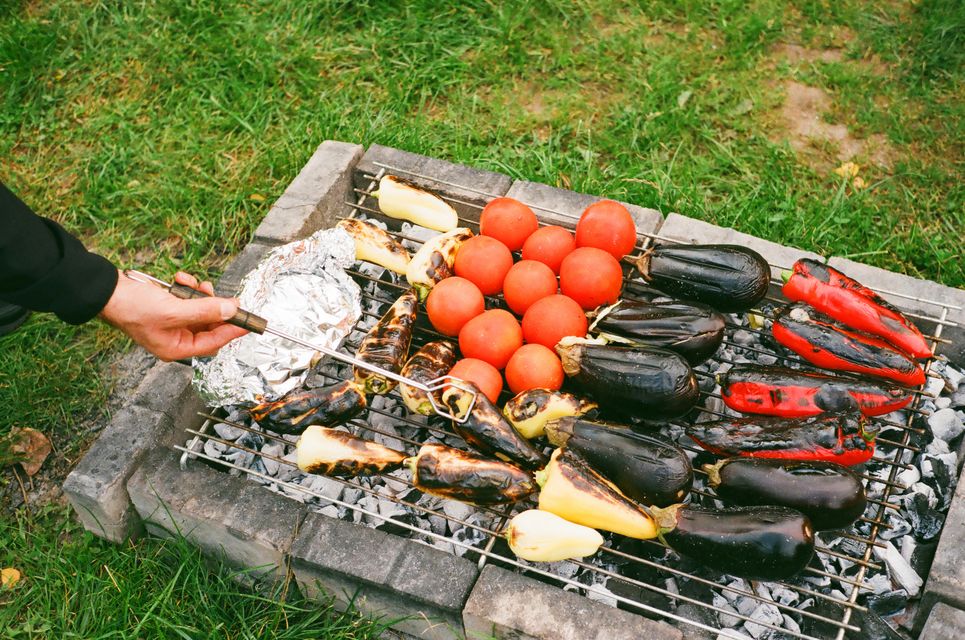 Auberginen, Tomaten, Paprika auf einem Grill.